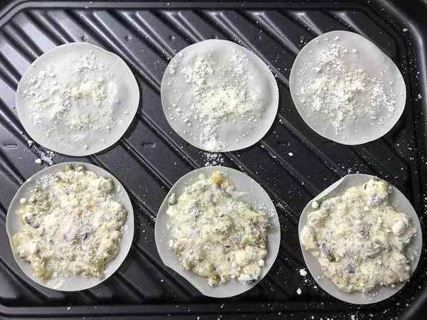 オーブンバットに並べたピクルスマヨと業務スーパー粉チーズがついた餃子の皮