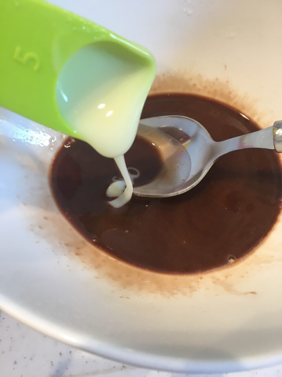牛乳とチョコソースを混ぜたところに練乳を加える
